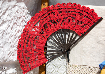  A red lace fan on display in a store in Alberobello. Italy