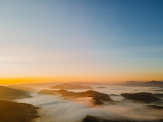 aerial view of sunrise above mountain range