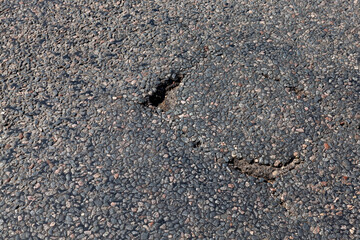 paved road with a lot of holes