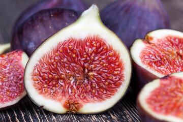 ripe purple figs on a wooden table