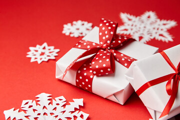Christmas gift boxes with white snowflakes on red