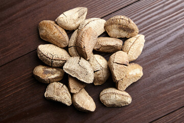 Brazil nuts or Bertholletia excelsa seeds on wooden table