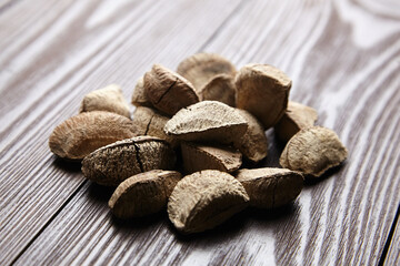 Brazil nuts or Bertholletia excelsa seeds on wooden table