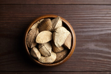 Brazil nuts or Bertholletia excelsa seeds in bowl on wooden table
