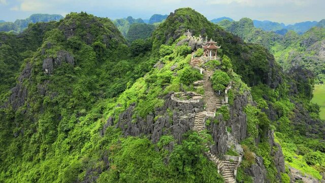 Walking up on the steps to Hang Mua dragon stone in Ninh Binh Vietnam