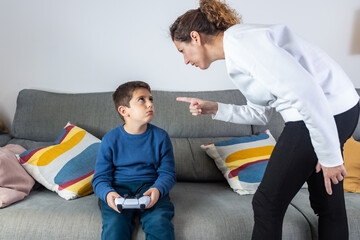 Mother angry with her son because he plays video games