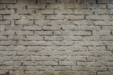 Brick wall with coarse cement rendering finish