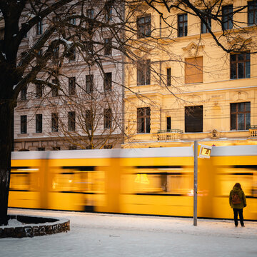 Waiting person in front of a tram in winter 