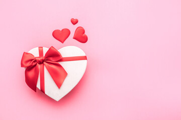 Love Valentine's Day. Love background. Gifts in the form of hearts on a pink background with the inscription love. Copy space for text. The concept of romance and love. square format. word