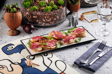 Gourmet bacon bruschetta appetizer dish on decorated background