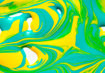 Beautiful abstract background with spots of blue, pink, green, yellow and purple paint. Oil paint, flowing down the canvas, shimmers with galagrophic paints with neon illumination.