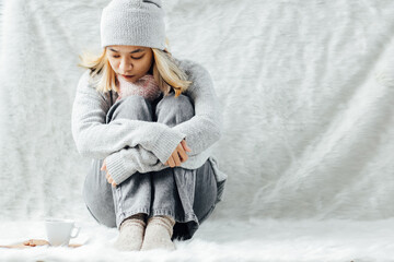 A blonde girl feeling lonely on winter