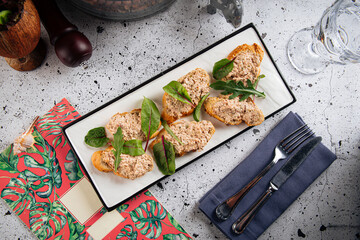 Gourmet tuna bruschetta appetizer dish on decorated background