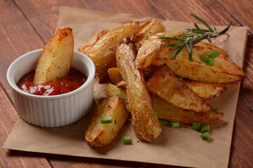 Baked, fried  potato  wedges with spices and rosemary