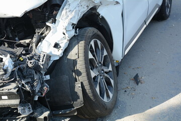 Car crash or accident. Front fender and light damage . Broken vehicle detail or close up.