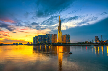 Naklejka premium Riverside urban area at sunset sky after a period of social distancing because of the pandemic has revived in Ho Chi Minh City, Vietnam