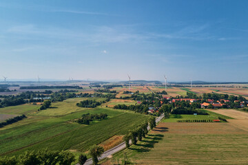 Small village near wind turbine generator, aerial view