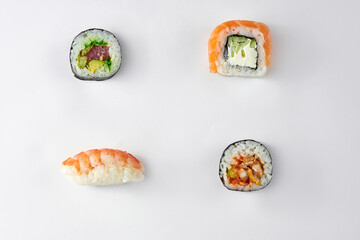 Pattern of different types of sushi rolls with tuna and salmon on a white background