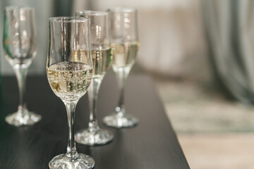 Close-up of champagne glasses in a row on the table. Copy space.