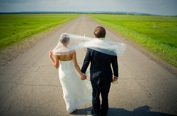 bride and groom stay on the road