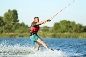 Man wakeboarding on river. Extreme water sport