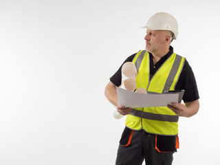 Builder engineer on white background. Engineer in yellow vest. Construction helmet on head of engineer. Career in engineering company. He holding some papers in his hands. Worker construction company
