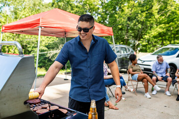 Manning the grill at a tailgate party