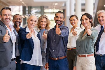 Group of successful business people showing thumbs up - Powered by Adobe