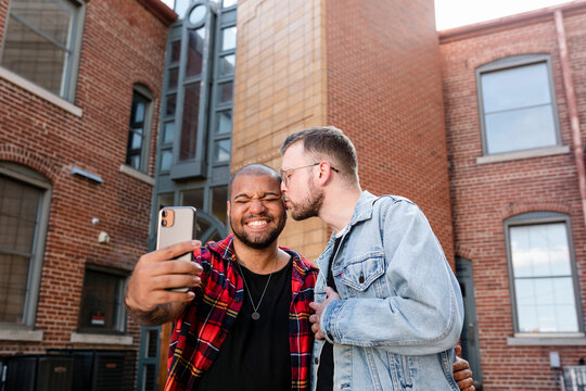 Gay couple taking selfies on a date