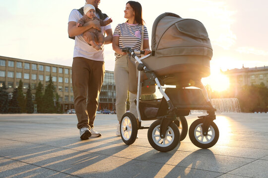 Happy parents walking with their baby outdoors