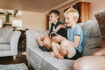 Blond kids playing video game in living room