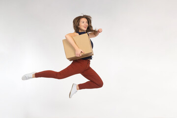 Happy woman with box. Concept she is happy receive package from internet. Girl jumping holding...