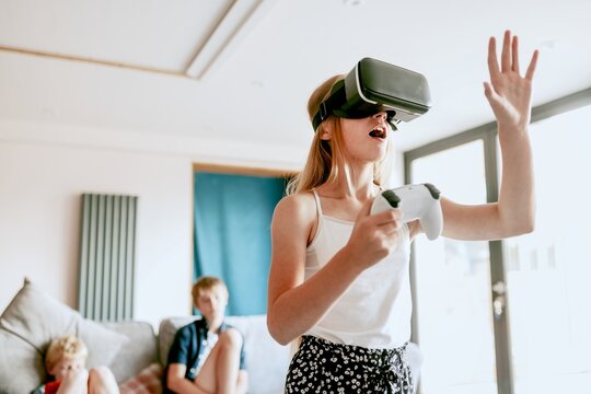 Young girl playing VR game at home