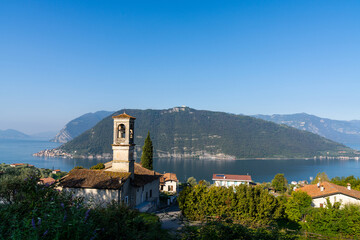 Fototapeta premium view of the Iseo Lake in northern Italy with an old mountain village and hcurch i nthe foreground