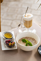Served breakfast with porridge and croissant on restaurant table