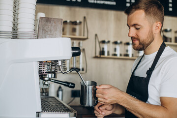 Male barista preparing coffee in a coffee house