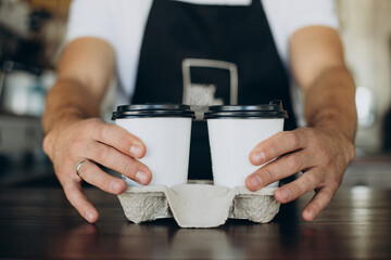 Barista standing by the counter in a coffee shop