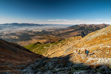 Touristts hiking on mountain trail to peak Krivan in High Tatras mountains, Slovakia