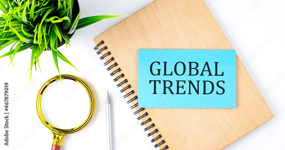 Poster notebook with tools and notes with text on the blue sticker global trends