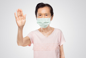 old asian woman wearing mask shows forbidden pose