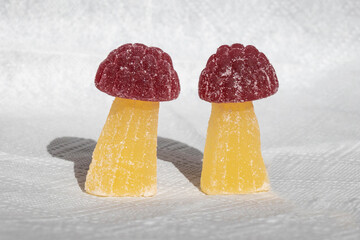 Mushroom figurines made of marmalade on a white background. Citrus marmalade. Raspberry marmalade figurine.