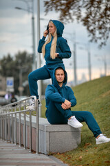 young couple in tracksuits walking around the city