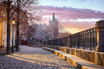 Prague, Czech Republic. Sunrise sunshine sunbeams and shadows on paving stones from promenade from...