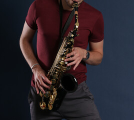 Naklejka premium Saxophone Player Saxophonist playing jazz music. Sax alto Jazz Musician hands closeup 