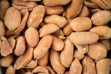 Closeup on scattered peanuts background texture