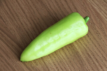 green pepper on wooden background.