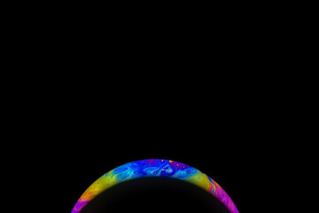 Abstract multicolor psychedelic planet in universe. Closeup soap bubble like an alien planet on dark background