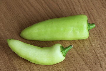 green pepper on wooden background.