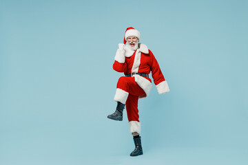 Full body happy old Santa Claus man 50s in Christmas hat red suit clothes do winner gesture isolated on plain blue background studio. Happy New Year 2022 celebration merry ho x-mas holiday concept