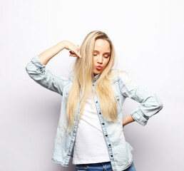 Fototapeta premium Young smiling blond woman with long hair wearing casual over light grey background.